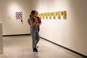 Two people looking at Madame X by Xia Zhang