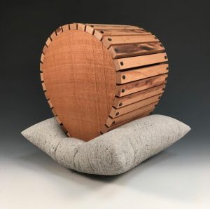 A sculpture of concrete and found pinewood by M. Paige Ward