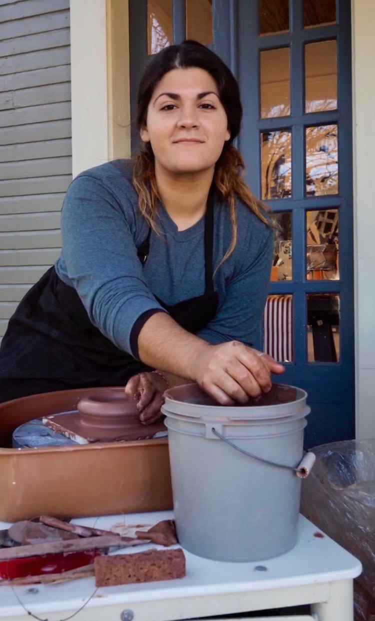 Sara Pratt in Action- image of her throwing clay on the wheel.