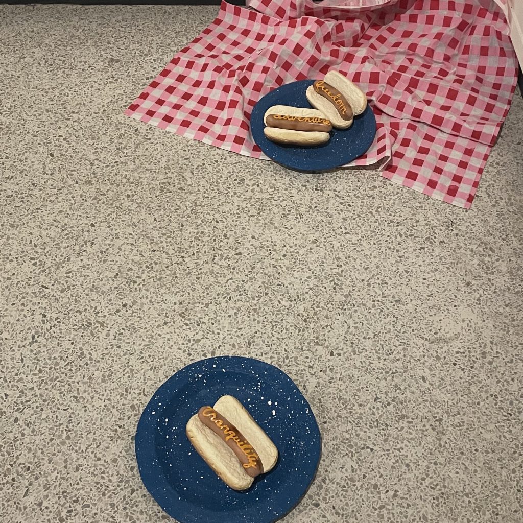 Fake hotdogs with fake mustard on it.