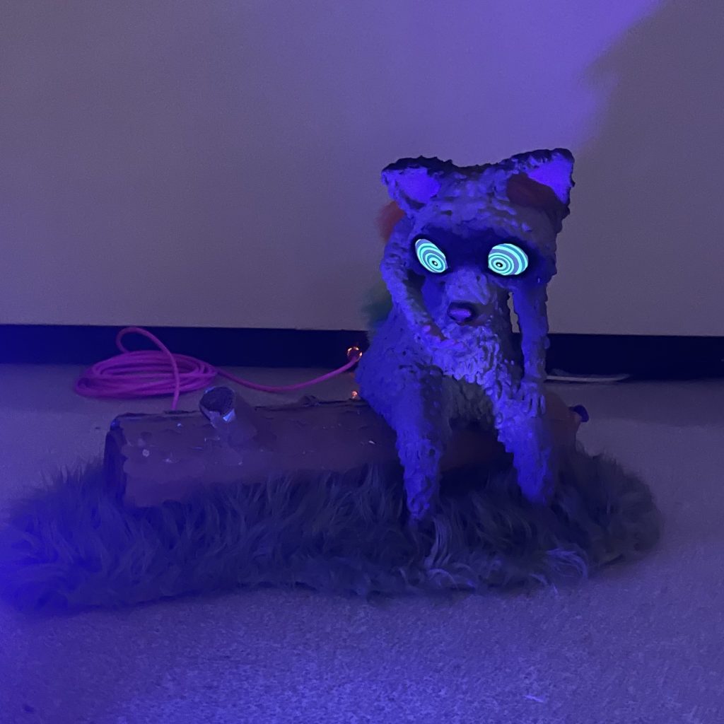 Racoon sculpture lit up with LED lights. 