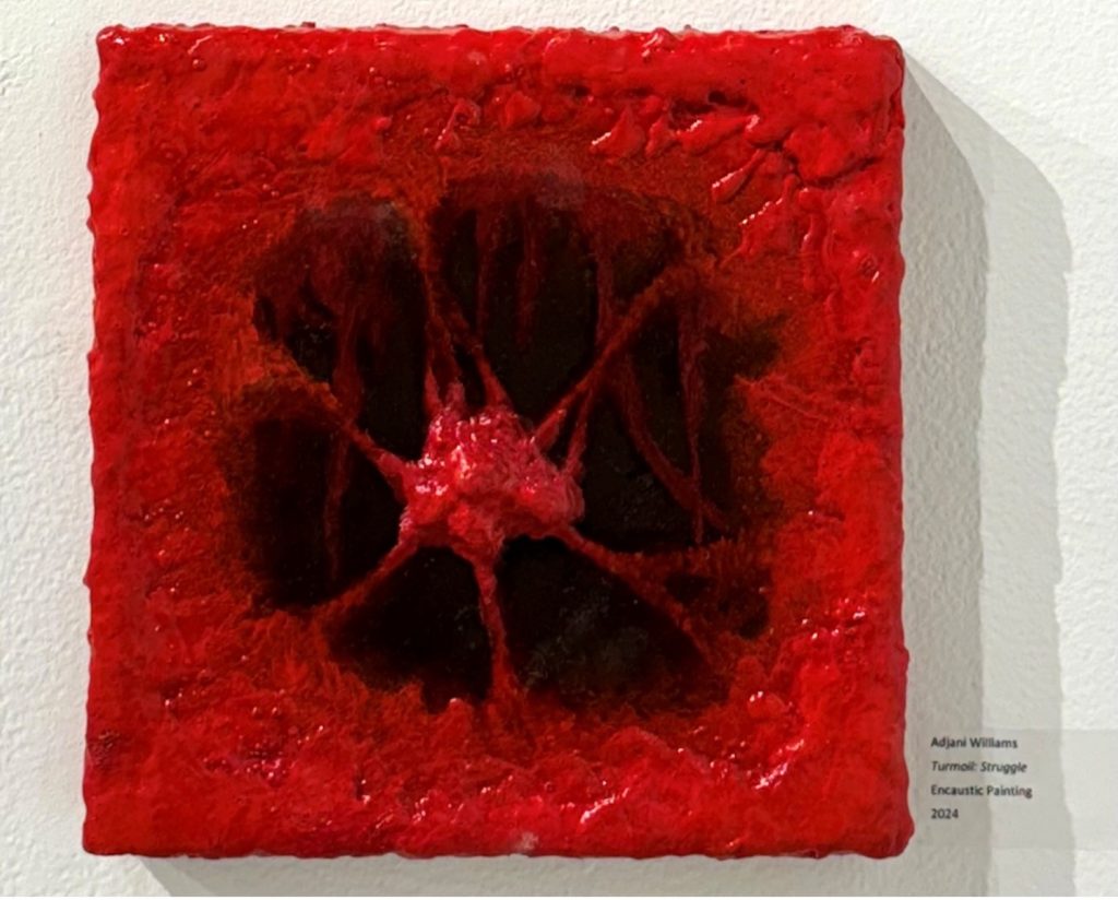 A painting out of melted wax mixed with colored pigments of red and black, black being the background, while red is predominant. In the center is a lumpy, small heart, held up in red strands on the thick borders. The outside surrounds the heart, encasing the mass in such a tight space of black.